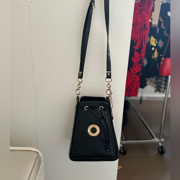 Small Black Crossbody Bag with Gold Accents and Drawstring Closure - Picture 2 of 13